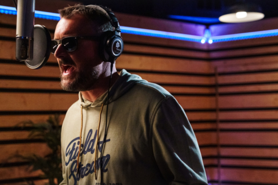 Man sings in recording booth