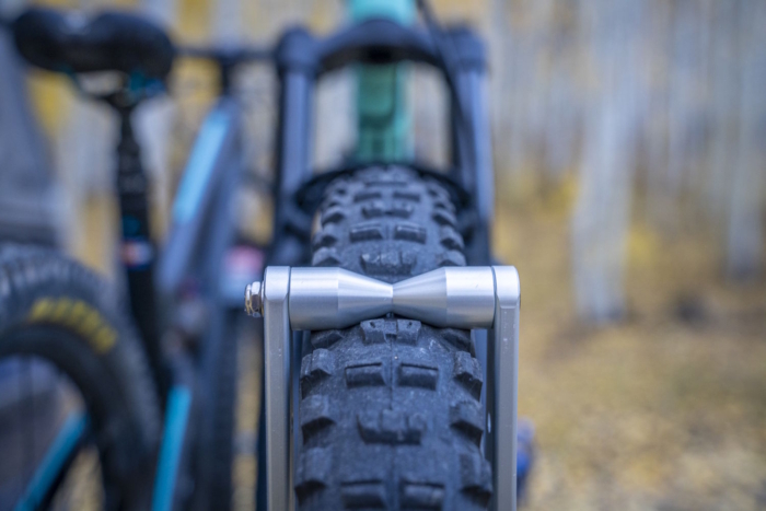 Front view of a bike tire secured between the 1Up rack’s metal rollers