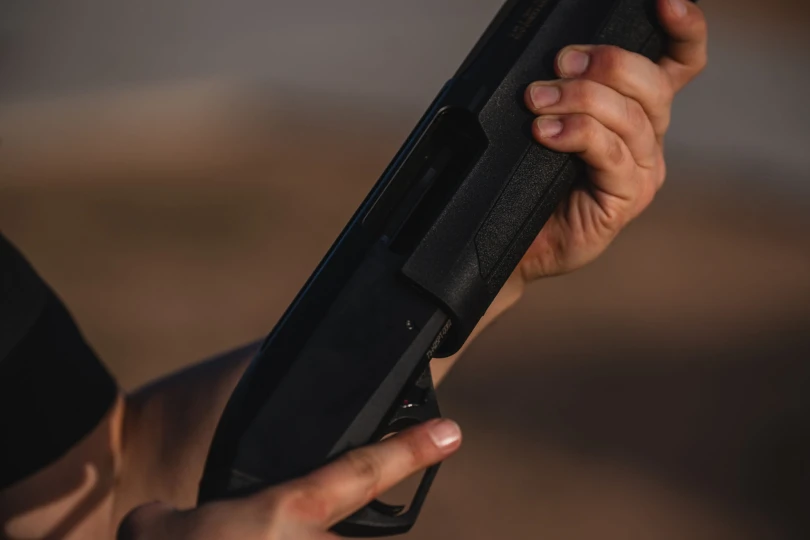 Man holding Redfield Shotgun