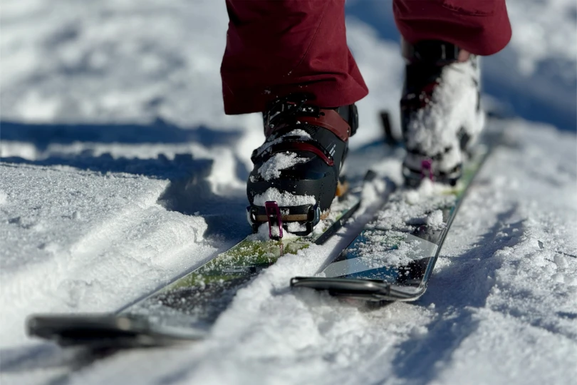 The touring boot stepping into the ski track during an uphill glide
