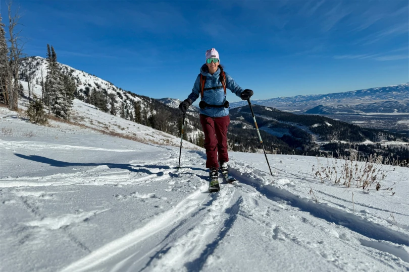 Skinning uphill with winter mountains stretching in the distance