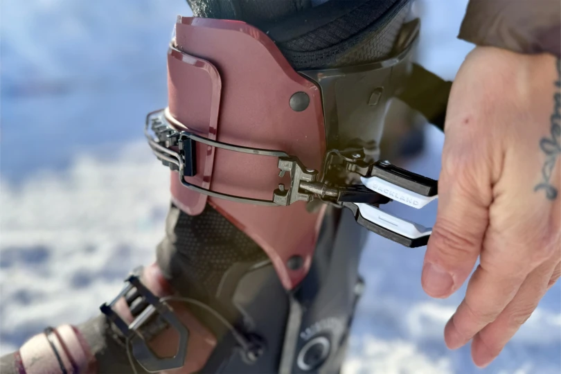 A close look at the boot buckle being adjusted by hand
