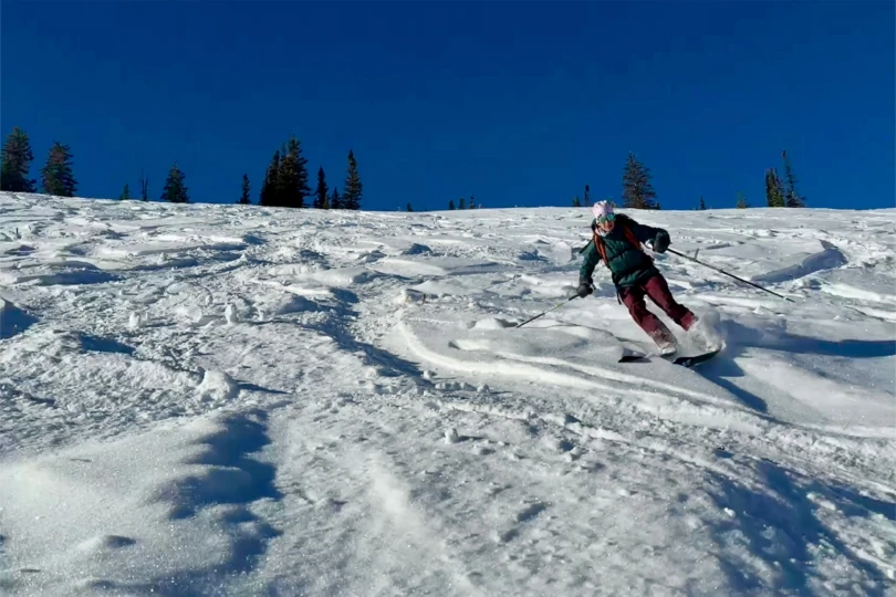 Skiing down firm snow with the touring boots driving the turns
