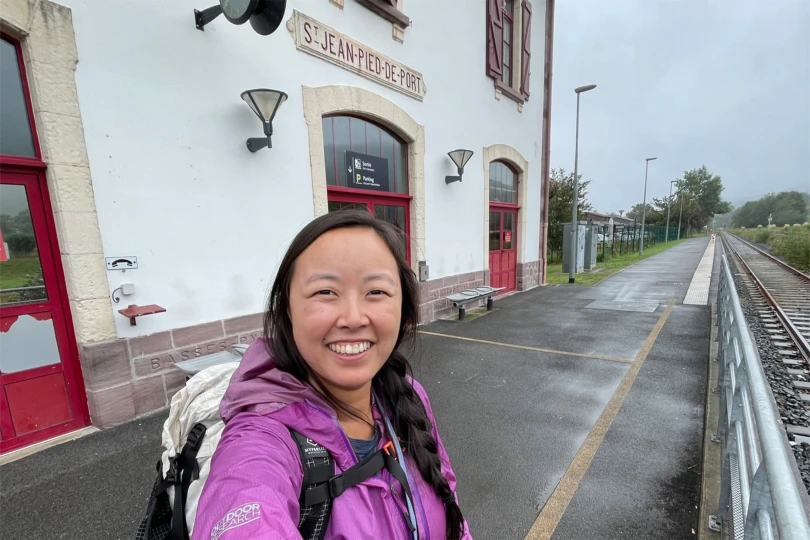 A hiker stands at the St-Jean-Pied-de-Port train station at the start of the Camino trail