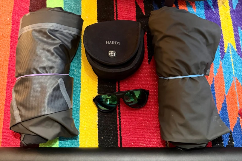 The Columbia PFG Force XII™ ODX Bib and Jacket packed and laid out with fishing accessories