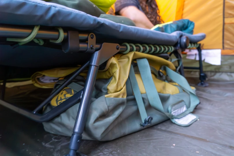 the wonderland comfort cot in a tent with a duffel bag underneath it