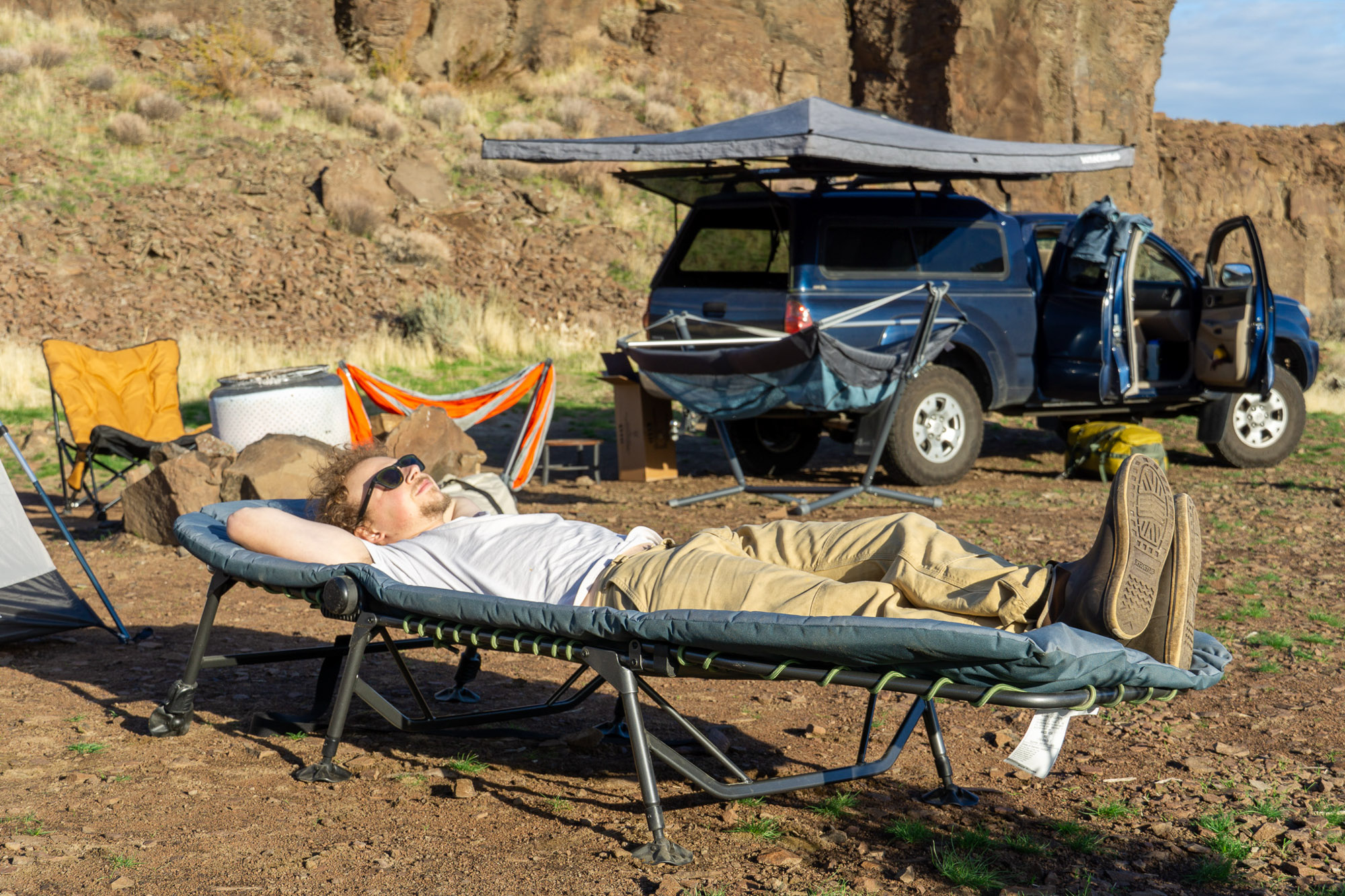 the author laying on the comfort cot in camp in eastern washington
