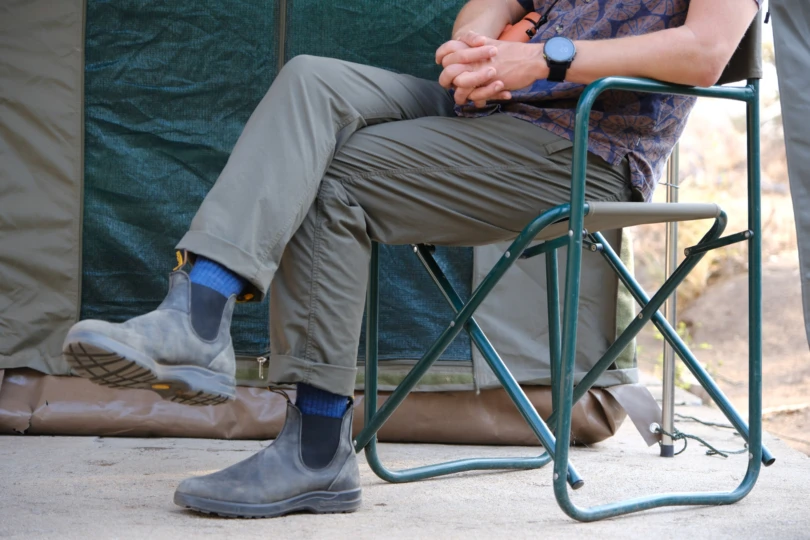 the author wears the roark pants while sitting in a camp chair in africa
