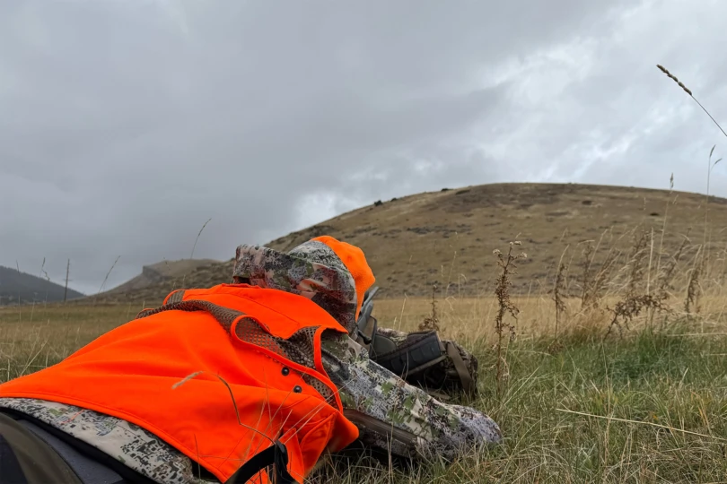 The FORLOH AllClima Soft Shell Jacket is worn while lying prone in wet grass during a hunt