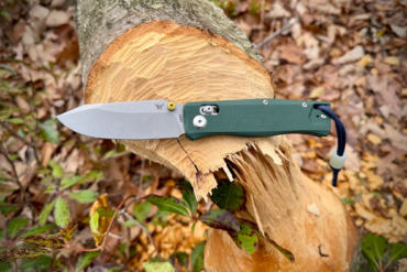 The BEEF knife on a freshly cut tree trunk outdoors