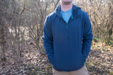 A tight shot of a man wearing the Free Fly Gridback Fleece Anorak Hoodie
