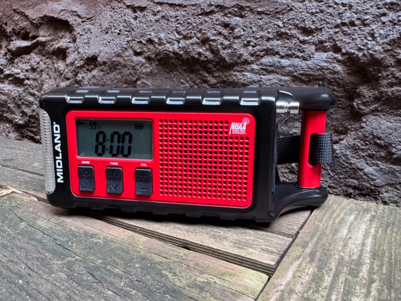 the er310pro radio sitting on a wooden bench outdoors