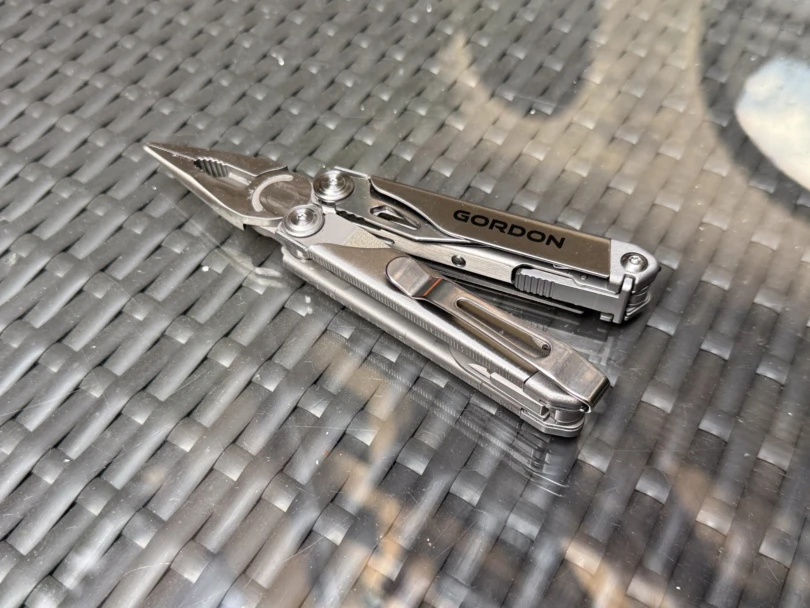 the gordon multitool with pliers extended on a table