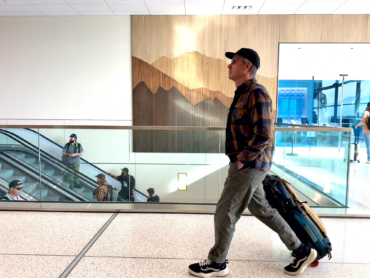 the author wearing the roark travel pants in an airport