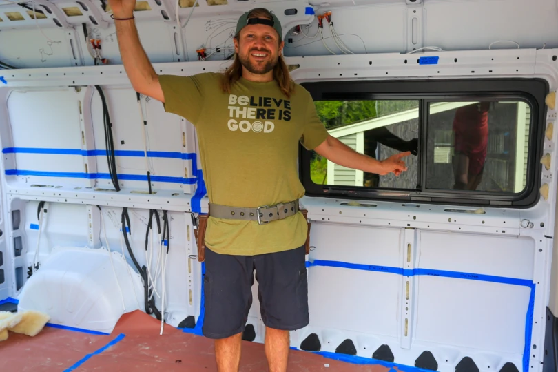 Interior of campervan build with tape marking component layout