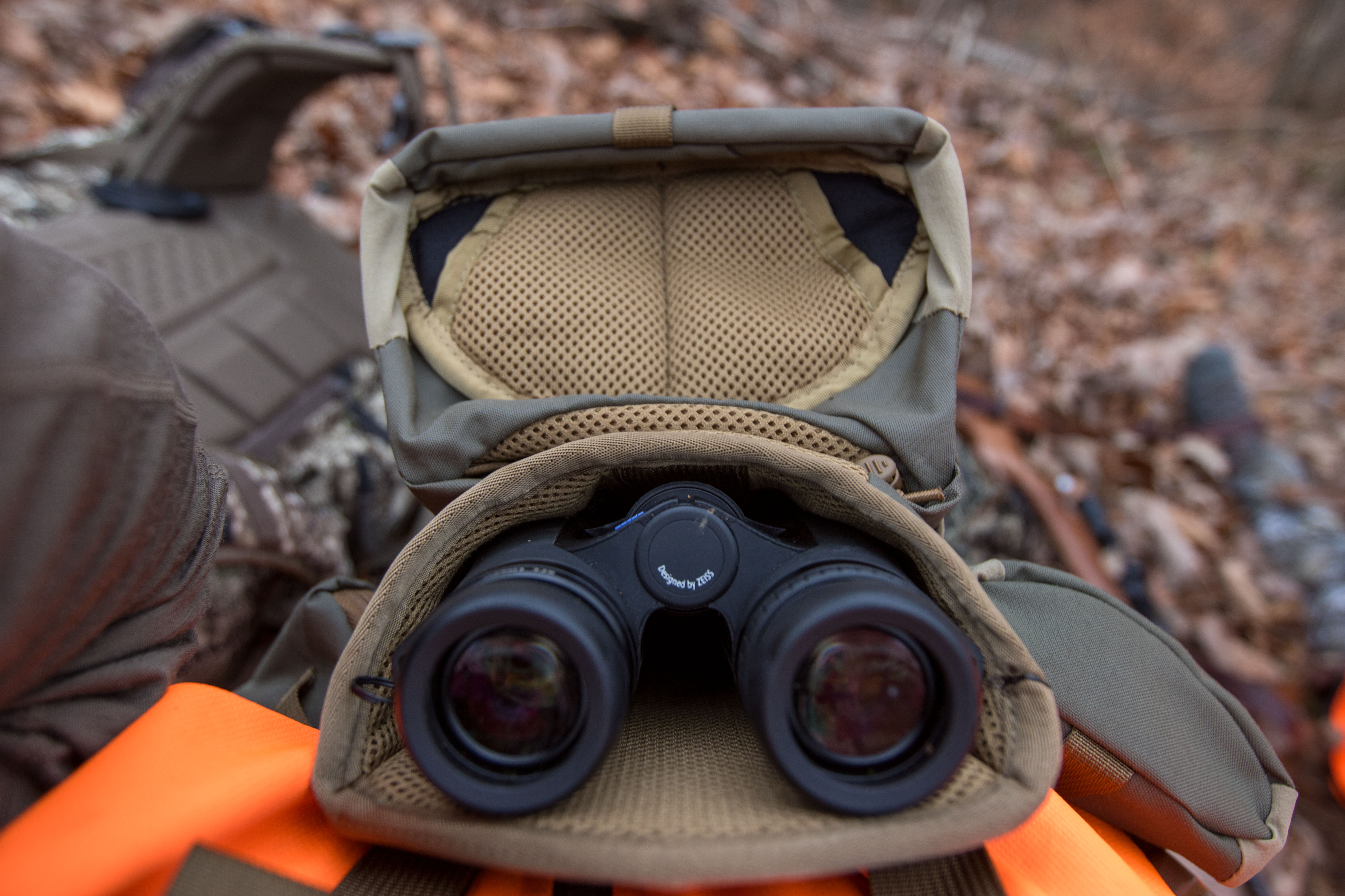 A pair of Zeiss SFL Binoculars resting in the Kifaru Standard Bino Harness