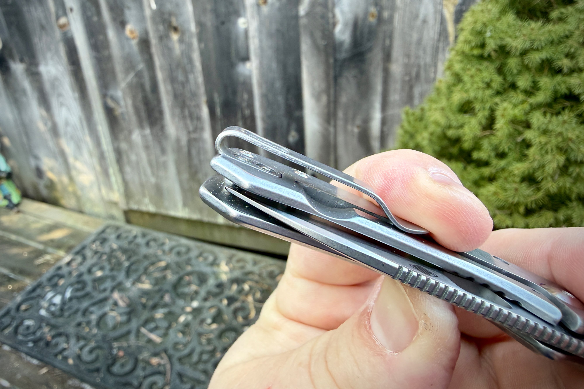 A close view of the knife’s deep-carry pocket clip while being held