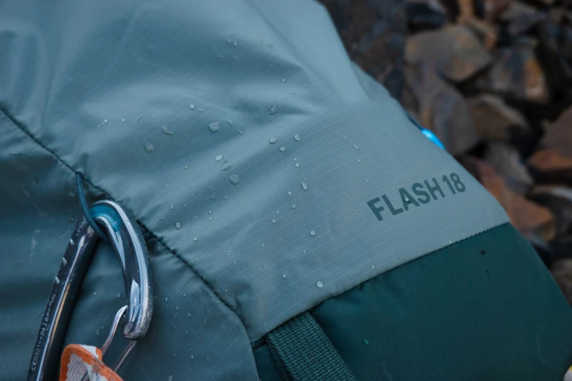 a detail of the flash 18 pack fabric, with water beading on the surface due to the DWR finish