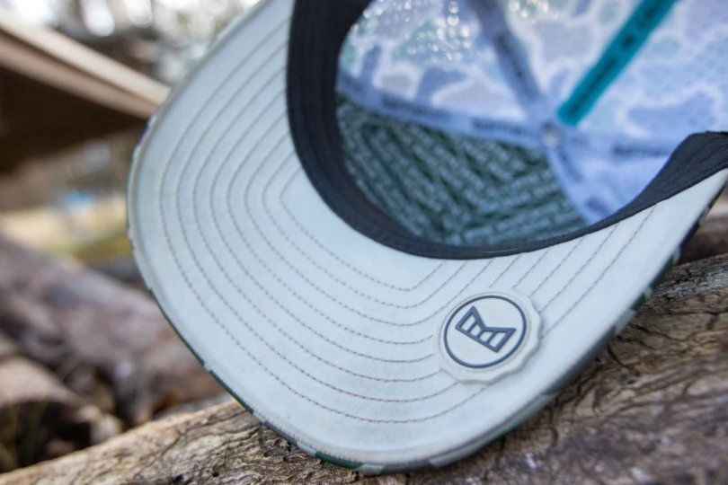 The rubberized thumb tab on the brim of the Melin Odysea Stacked Hydro Hat.