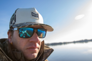 An angler wearing the Melin Odysea Stacked Hydro hat on the water.