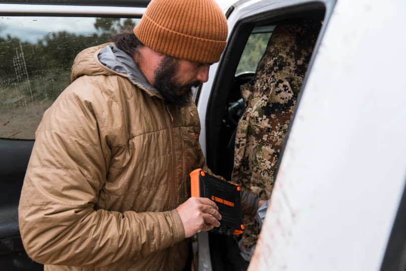 Holding the charger while loading gear into a truck
