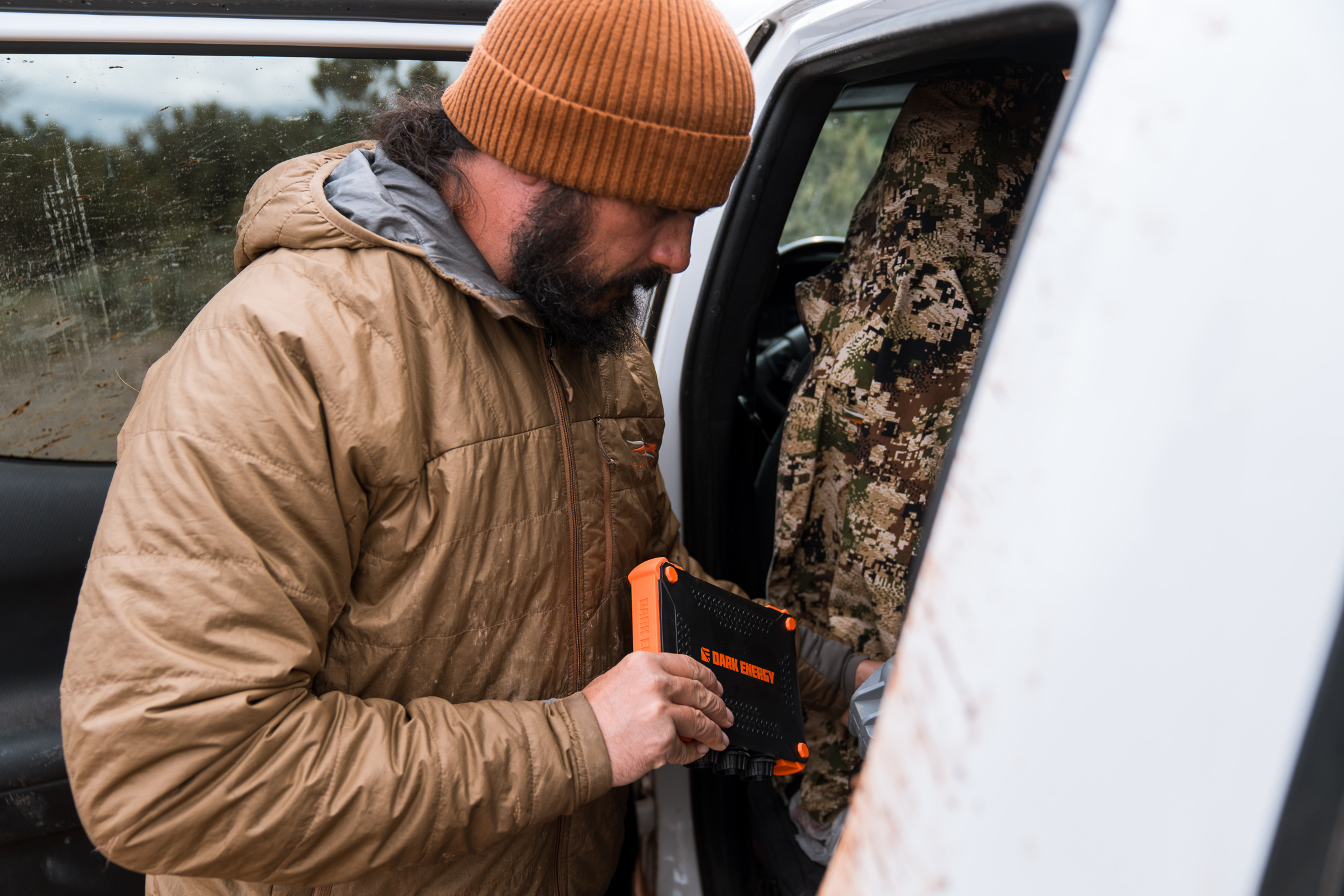 Holding the charger while loading gear into a truck