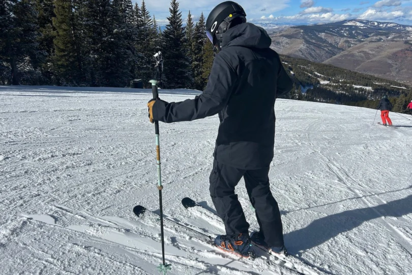 Side angle of the Flex1 pants and jacket while paused on skis