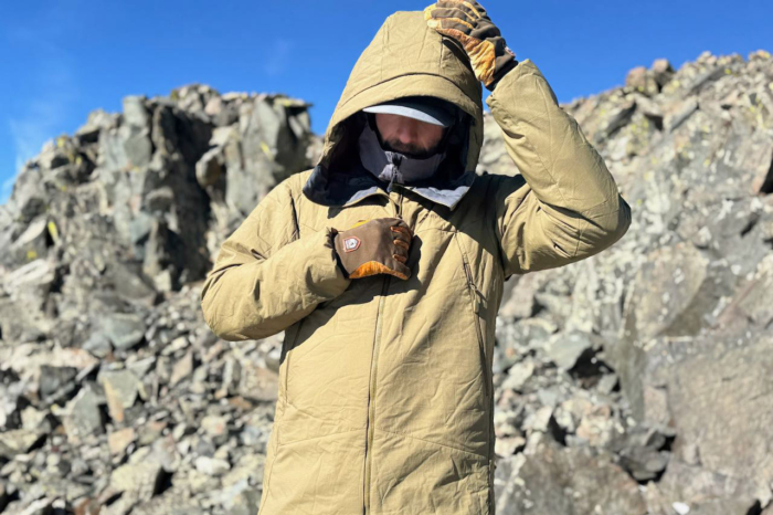 Front view of the Norrøna Møre Thermo60 Aero200 Jacket with the hood adjusted while standing outdoors