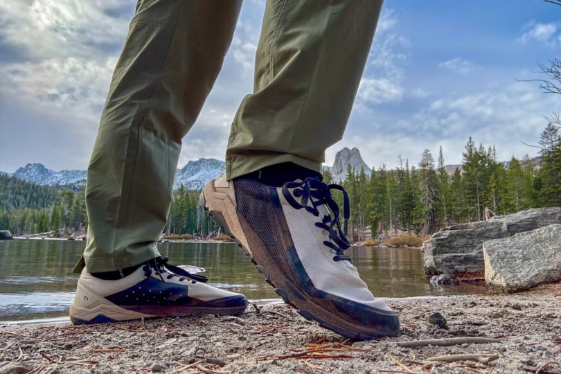 Women’s Barefoot Shoe stepping along a rocky lakeshore