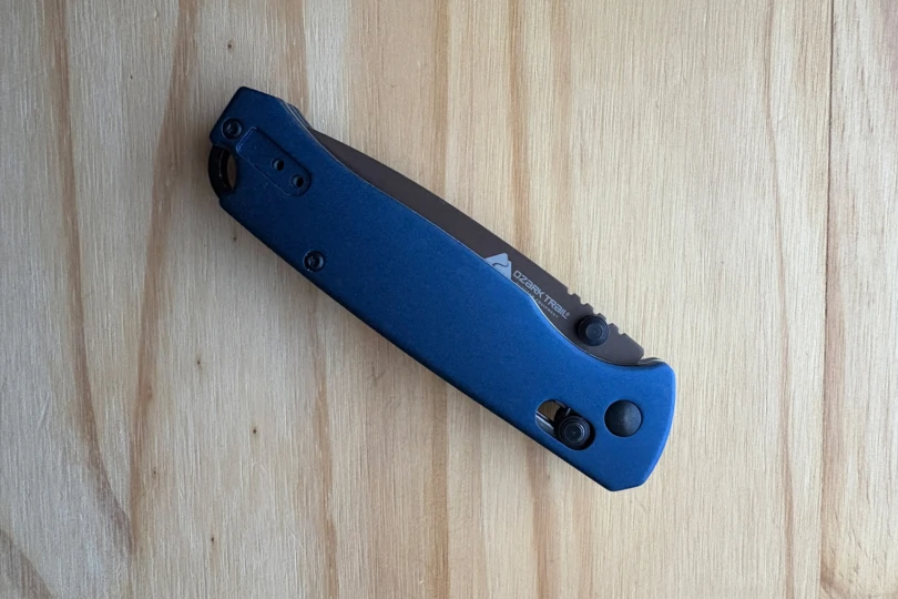 The Ozark Trail tanto knife is closed, showing the blue handle from the opposite side