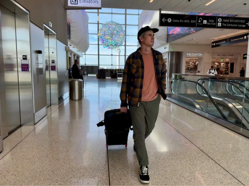 the author in an airport wearing the layover pro traveler pants