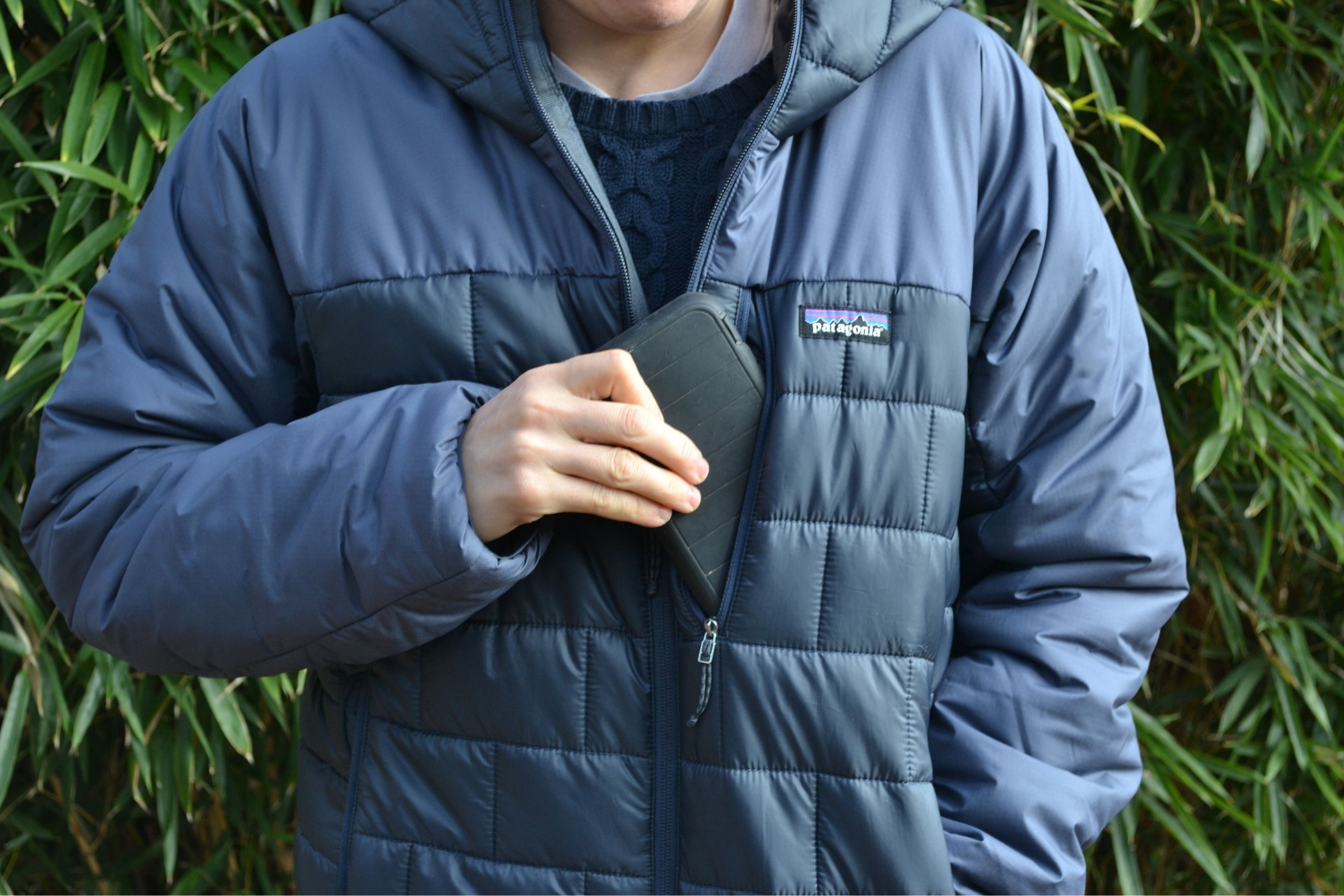 phone being pulled out of chest pocket on jacket