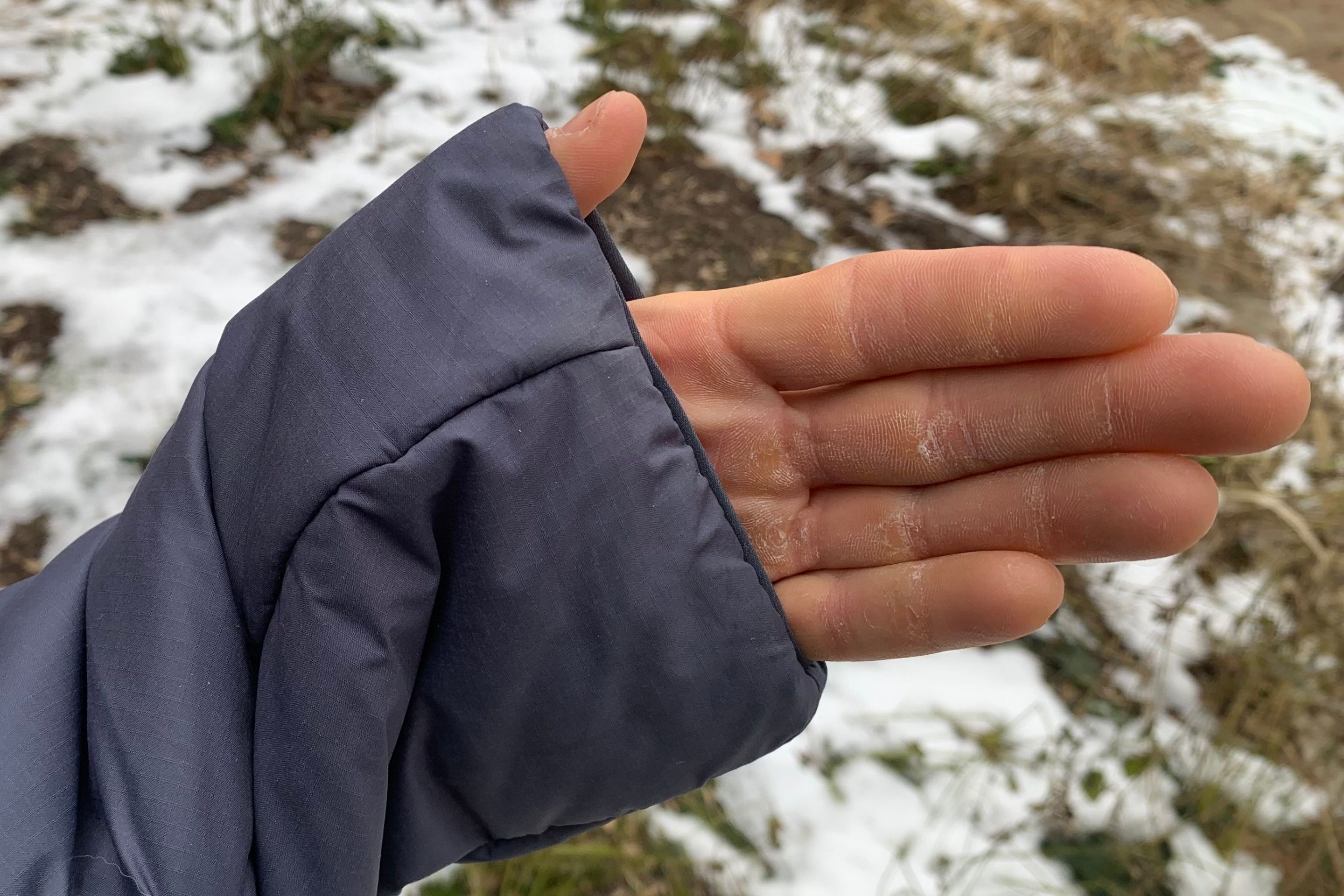 close up shot of hand in jacket sleeve