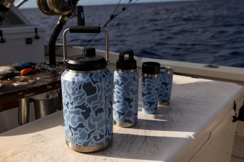 series of blue camo water bottles on boat