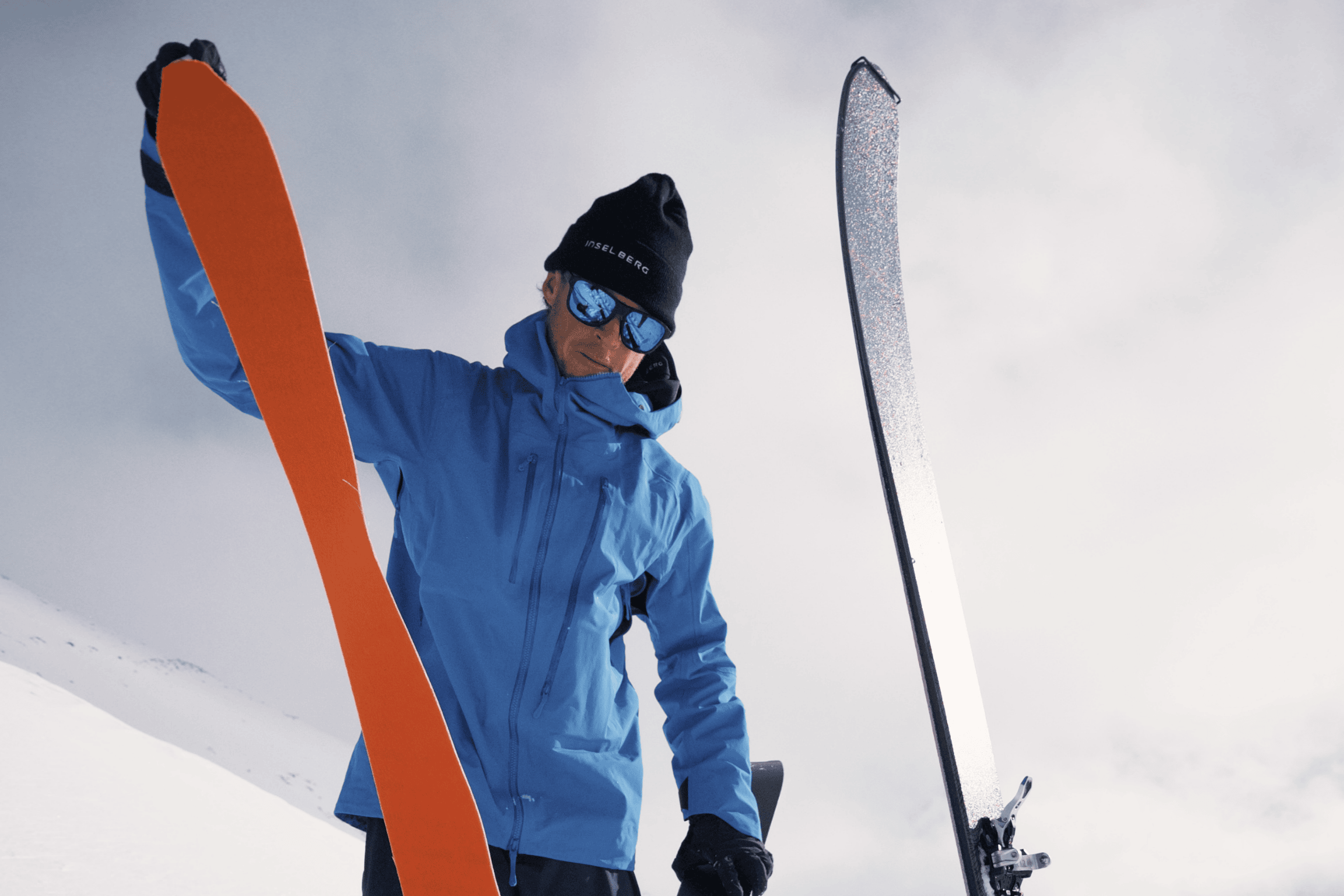 Person pulls skin off ski wearing blue jacket