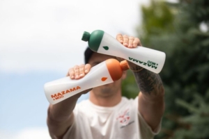 Person squeezing two reusable plastic bottles