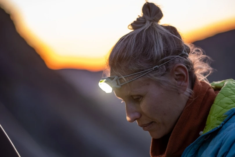 Woman wears headlamp turned on at dusk