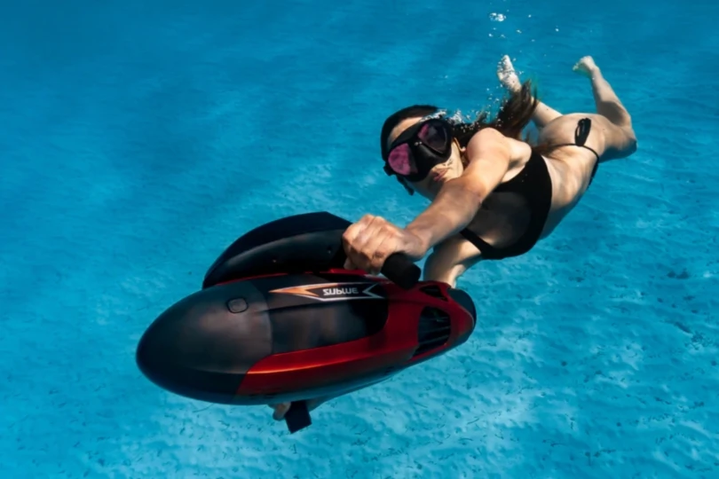 woman underwater with scooter
