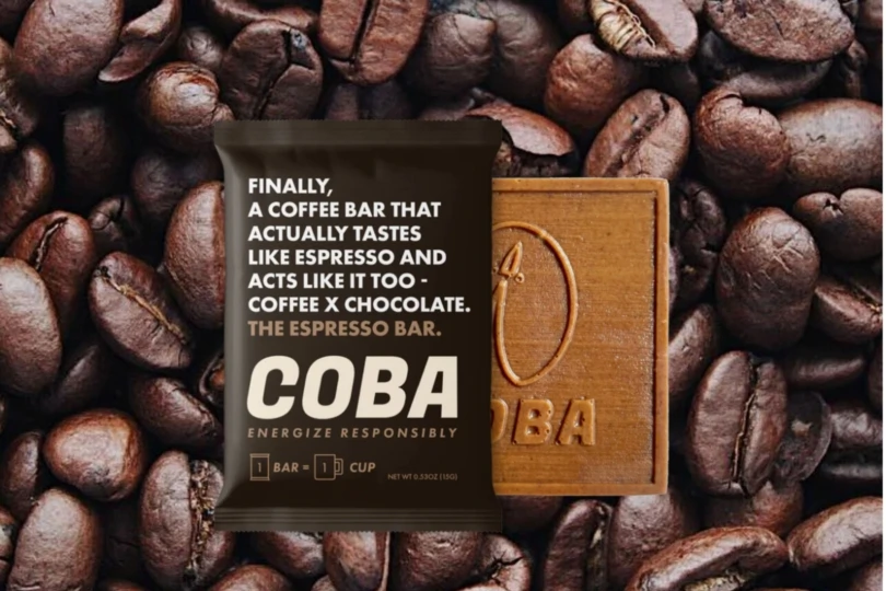 chocolate bar out of wrapper on background of coffee beans