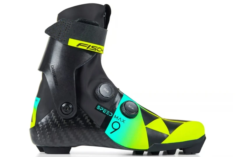 adjustable ski boot that's black with teal and green accdents