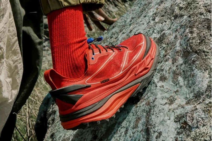 Close-up of red chunky hoka on rock