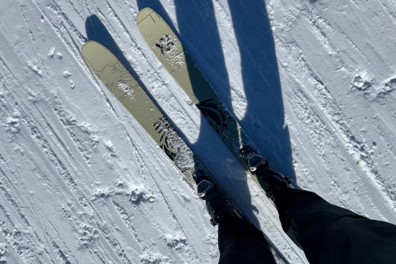 The Völkl Revolt 101 skis are shown from above while standing on a snowy slope