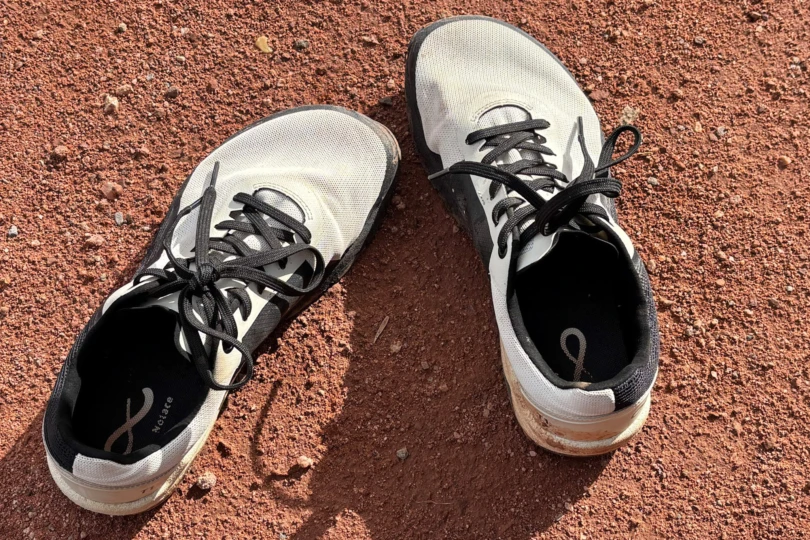 The Yama shoes resting on dry red dirt after a hike
