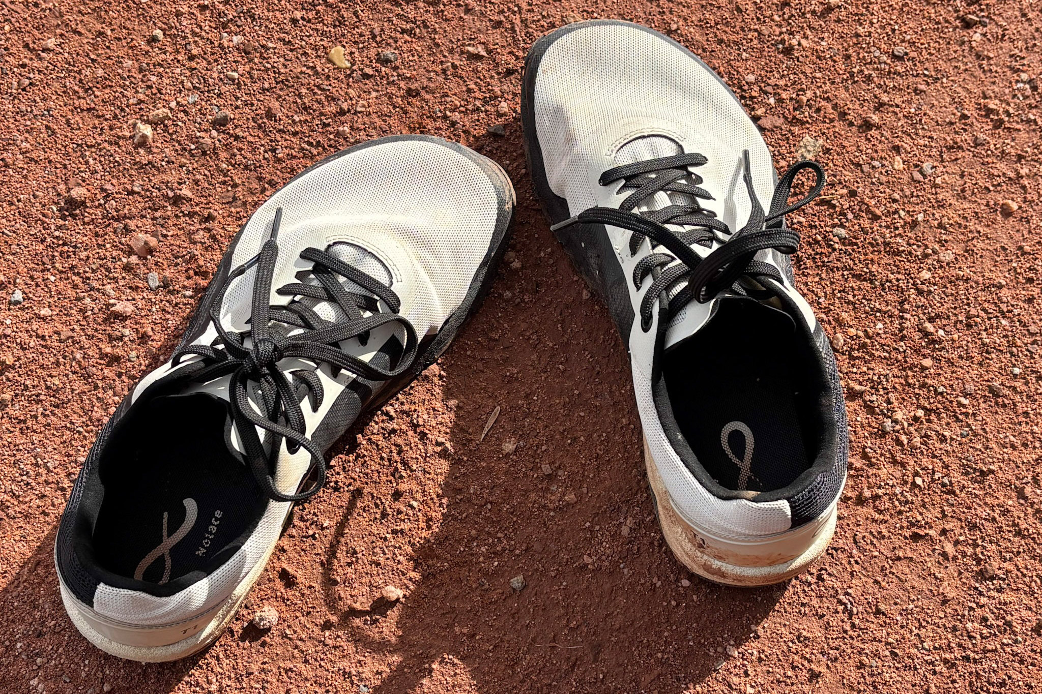 The Yama shoes resting on dry red dirt after a hike