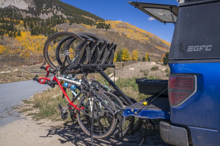 A set of bicycles secured on a rear rack of a truck