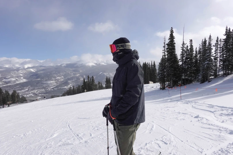 Standing on the ridge with the REI ski jacket in light snowfall