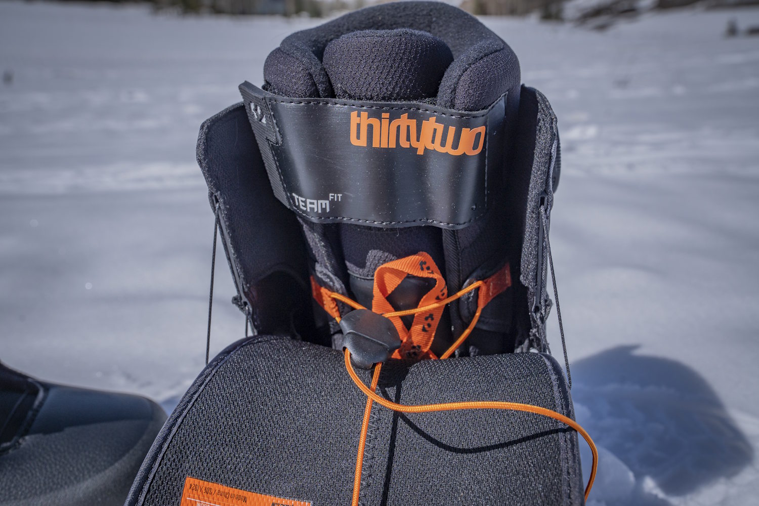 Close-up of a ThirtyTwo snowboard boot, showing internal lacing and padding.