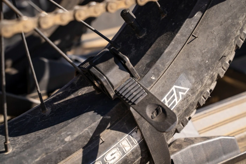 A close view of the wheel strap securing the tire in place