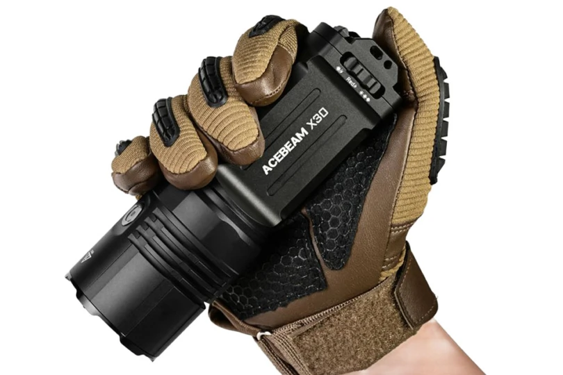 The Acebeam X30 flashlight in a gloved hand.