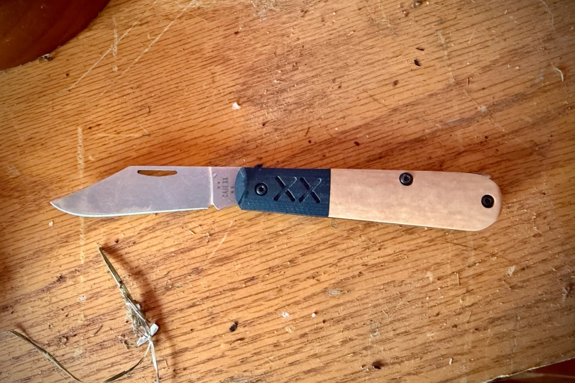 The Case Crossroads Barlow XR Knife opened and resting flat on a wooden surface